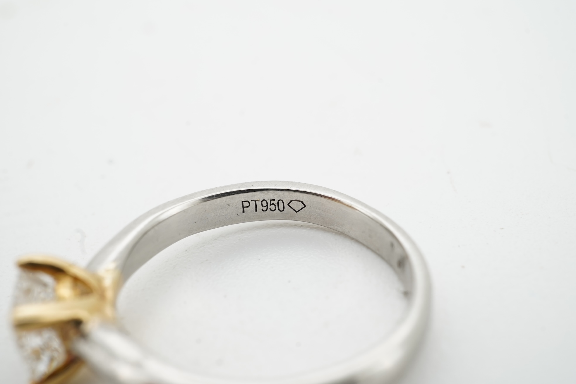 A diamond ring, claw-set with a princess-cut diamond weighing approximately 0.58 carats, mounted in platinum, size F1/2, British hallmarks, gross weight approximately 2 grams